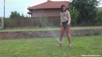 Brunette's Very Wet Sprinkler Frolic Screencap 44 on www.sinx.com