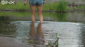 Seductive Blonde Smokes And Gets Drenched In Lake Screencap 6 on www.sinx.com
