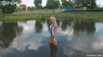 Seductive Blonde Smokes And Gets Drenched In Lake Screencap 9 on www.sinx.com