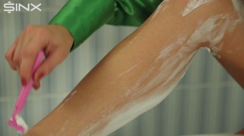 Fully Clothed Blonde Shaves Her Long Legs Screencap 18 on www.sinx.com