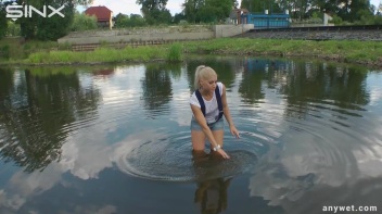 Seductive Blonde Smokes And Gets Drenched In Lake Screencap 10 on www.sinx.com